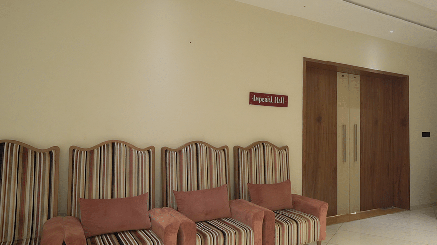 Entrance of Imperial Hall with a name plate and sofas kept outside.