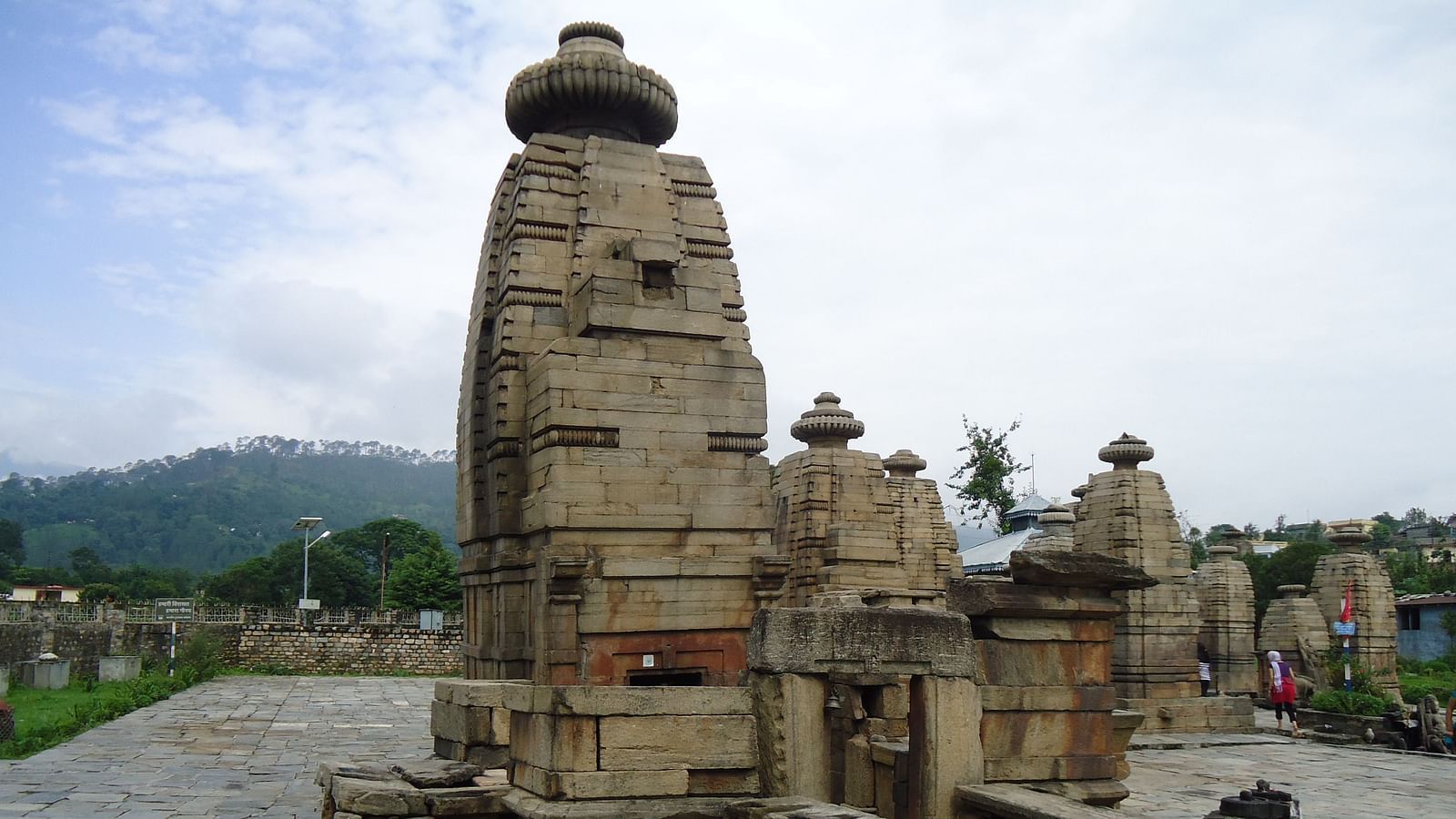  Ancient temple complex with towering structures and stone carvings.