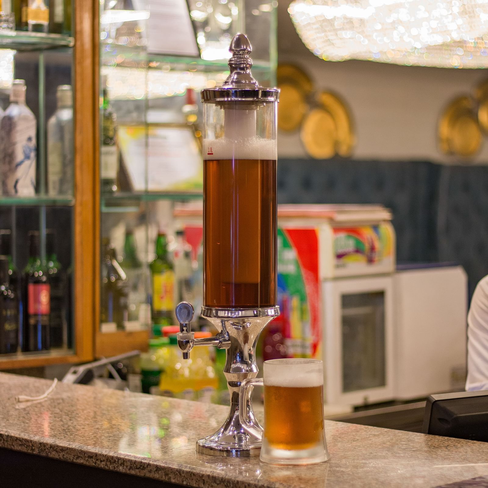 A fountain of a drink placed on the bar counter.
