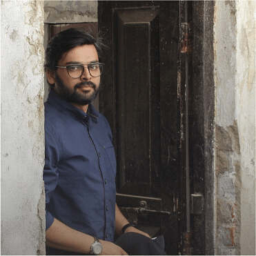 Photo of Abid leaning on a door