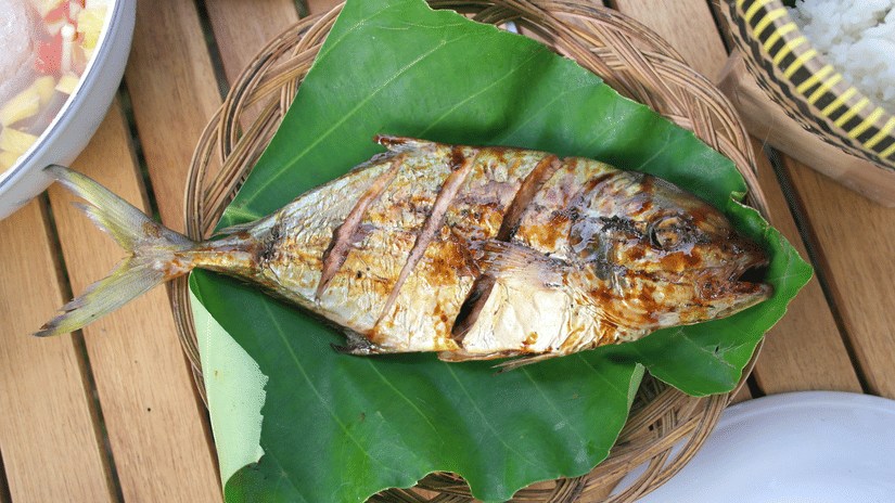 Freshly caught fish wrapped in banana leaves ready for cooking