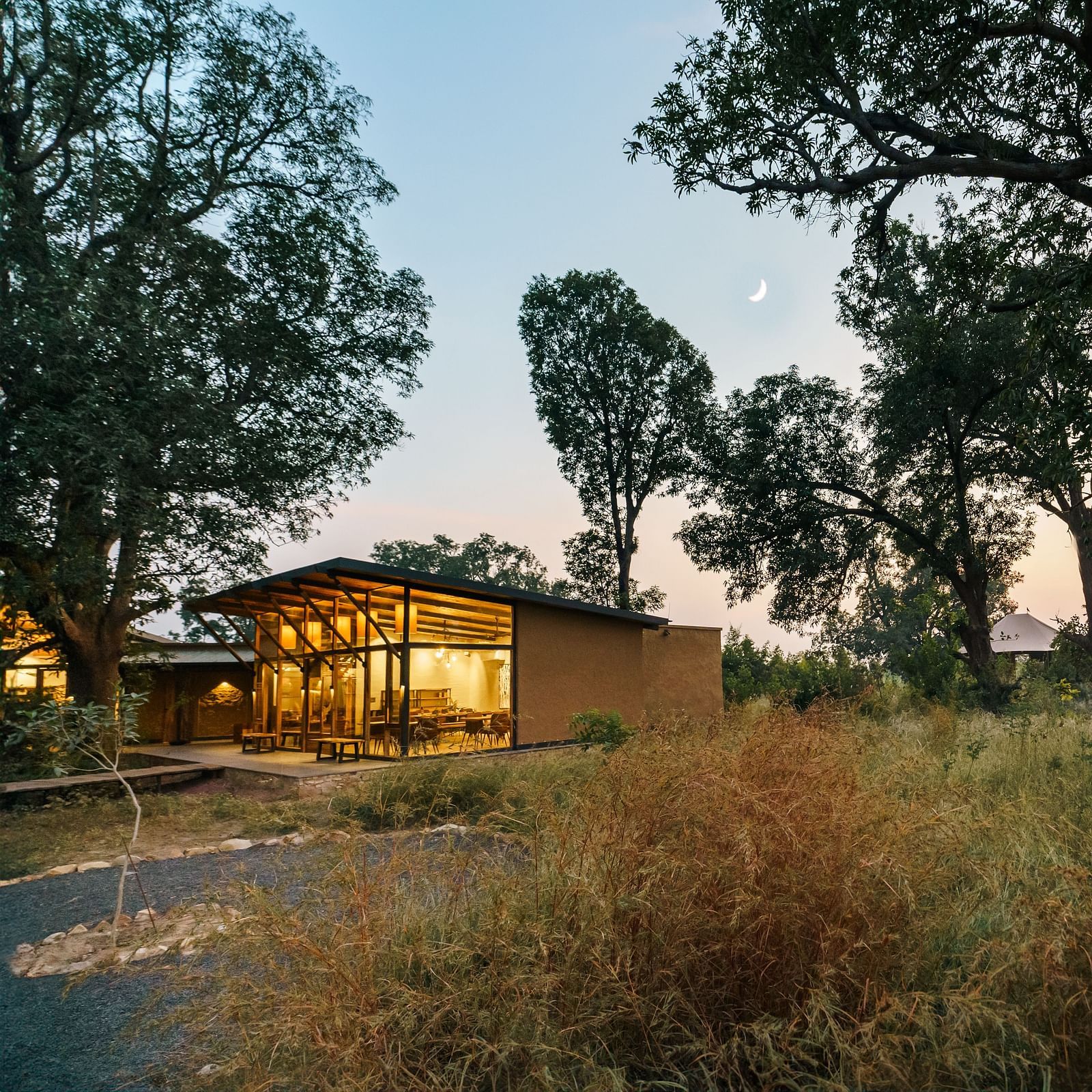 View of a hut amongst greenery at Trees N Tigers, Tadoba.