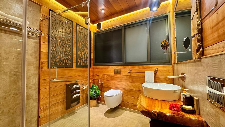 Well-appointed bathroom with a modern sink, mirror, and warm, indirect lighting - BluSalzz Collection - Tranquil Resort, Wayanad
