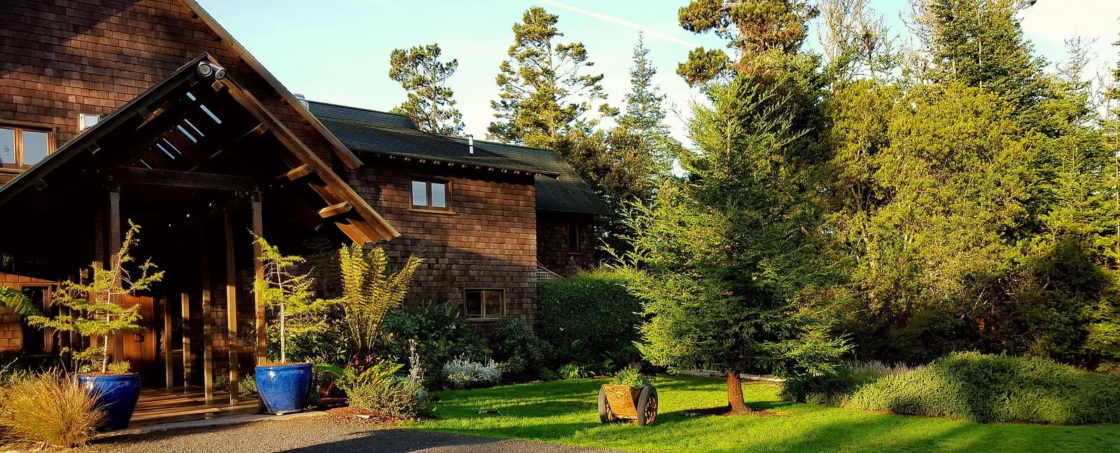 The entrance to our charming Inn surrounded by lush garden and golden sunlight - Brewery Gulch Inn & Spa