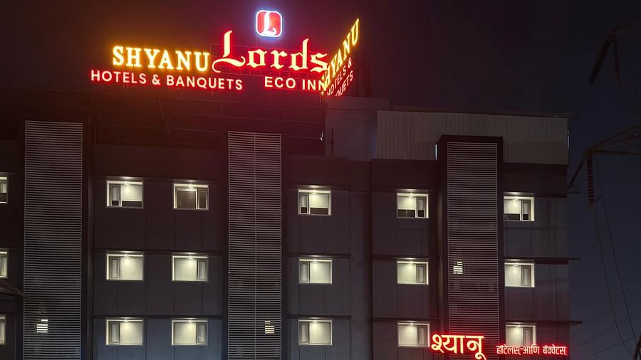 Night-time exterior view of the illuminated 'Shyanu Lords Eco Inn' hotel.