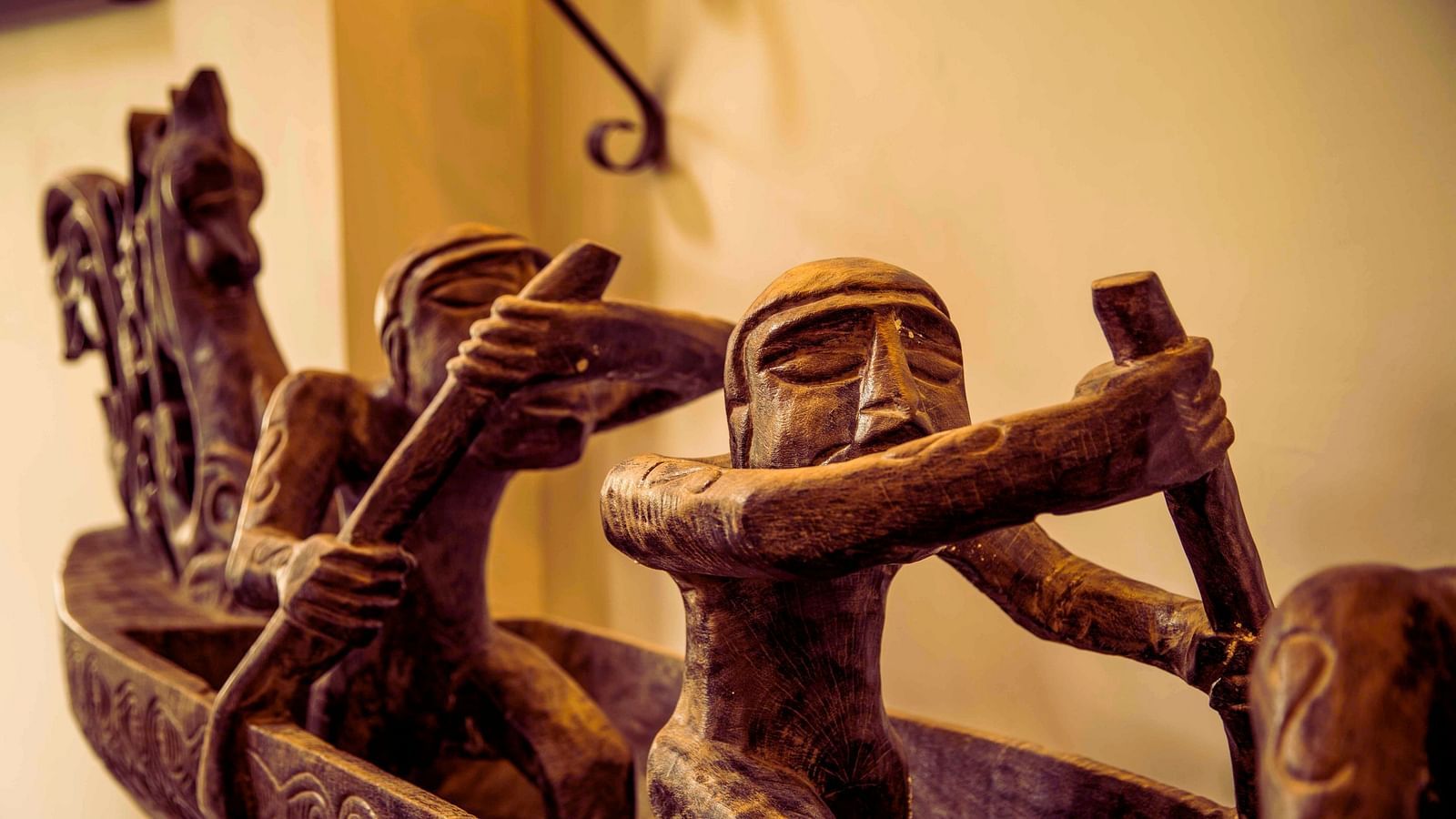 Wooden decoration resembles people rowing a boat - Rhythm Lonavala