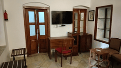 A study table with a chair next to a door inside Maharaja Raninder Singh room - The Baradari Palace