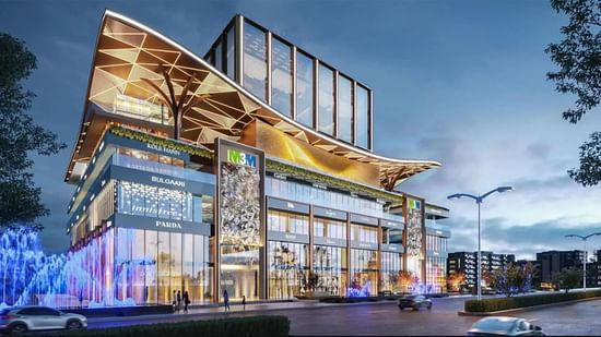 A facade image of a mall in Gurgaon with lights and shops