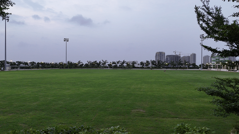 An expansive lawn with tall halogen lights put up in the perimeter - Pride Resort, Rajkot