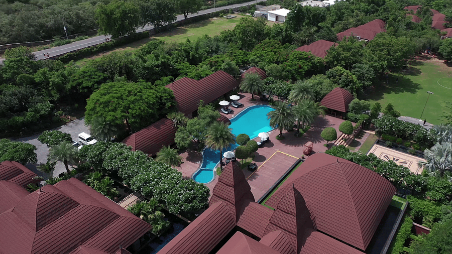 An aerial view of our 5-star resort in Pushkar featuring beautiful villas, lush greenery and an immaculate pool 