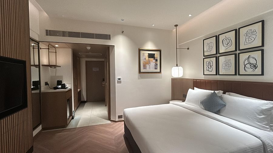 Deluxe Room with modern interiors, wall art, and comfortable bedding at Dolphin Hotel