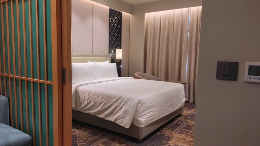 A view of a bedroom with a double size bed in a suite, from the living area - Serene Sarovar Premiere Hargeisa
