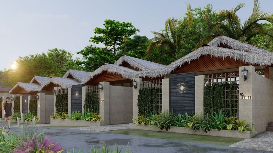 Havelock Water Villa at Symphony Palms Beach Resort And Spa featuring three hut style villas with concrete walls. Each villa has plants at the entrance, a designer door, and lamps.