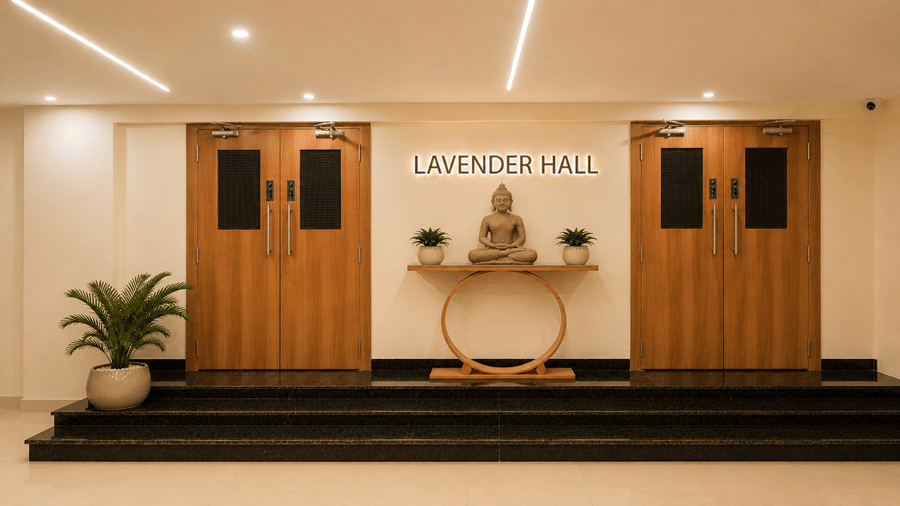 Pre-function area at Tulip Inn, Hoodi Whitefield, Bengaluru, showing doors, steps, a statue on a table, and signage reading Lavender Hall.