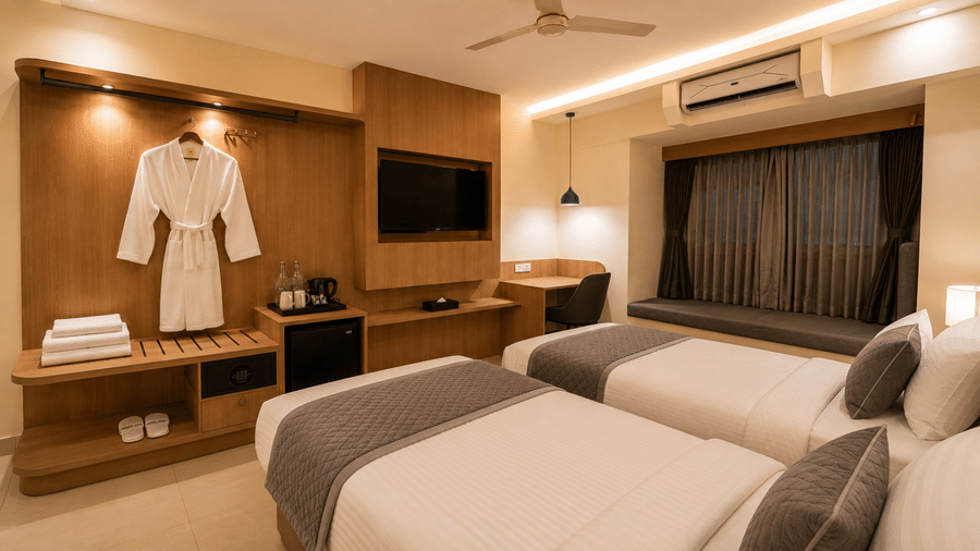 Guest Room at Tulip Inn, Hoodi Whitefield, Bengaluru, with 2 single beds, a television, a window seat, and a bathrobe on a hanger.