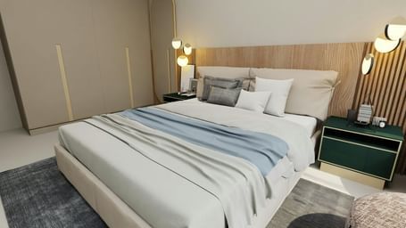 A modern bedroom with a bed featuring white and blue bedding, a nightstand with a lamp, and a headboard.