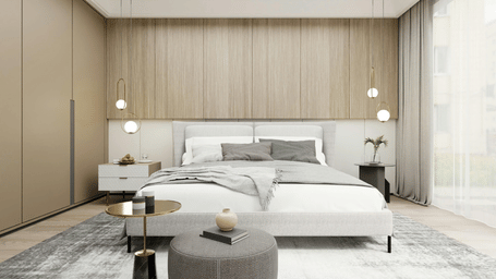 Double bed with white and grey linens, a wooden headboard wall, and 2 bedside tables, in a bright room.
