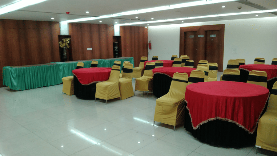 Banquet hall setup with colourful table covers and golden chairs, ideal for events at Pipul Utkal Continental, Jharsuguda.