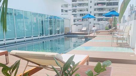 Overview of the Rooftop Pool Area with a lounger in view - Night Hotel Bangkok