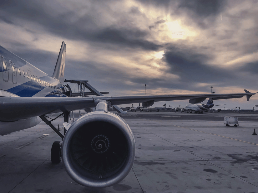 A close-up shot of an aircraft parked in an airport.