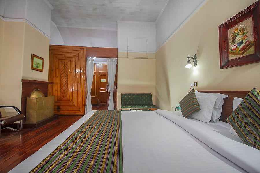 Heritage Club King Room at Central Heritage Resort & Spa, The Mall, Darjeeling - a spacious and elegant accommodation with classic decor and wooden flooring.