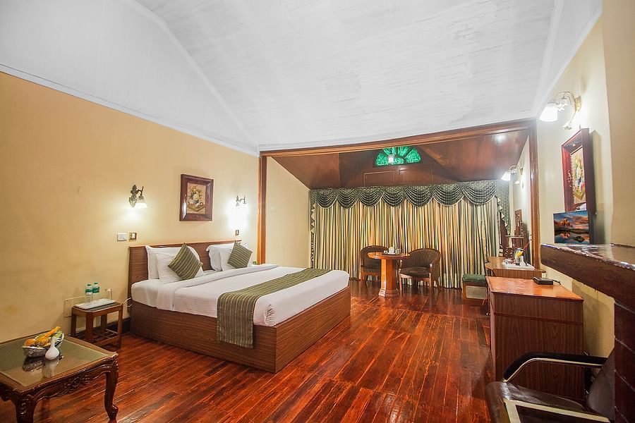 Heritage Club King Room at Central Heritage Resort & Spa, The Mall, Darjeeling - a spacious and elegant accommodation with classic decor and wooden flooring.
