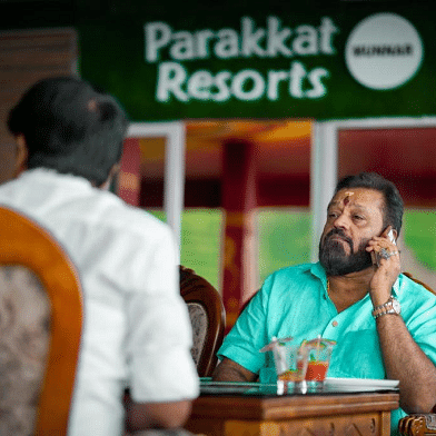 A man sitting on a table at Parakkat nature Hotel & resort, Munnar