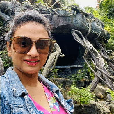 A woman clicking picture outside cave room