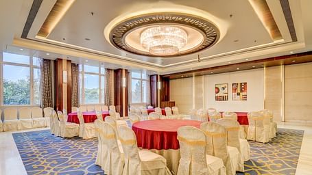 banquet hall with interior design and chairs at The SSK Solitaire Hotel & Banquets, Mumbai Naka - Nashik