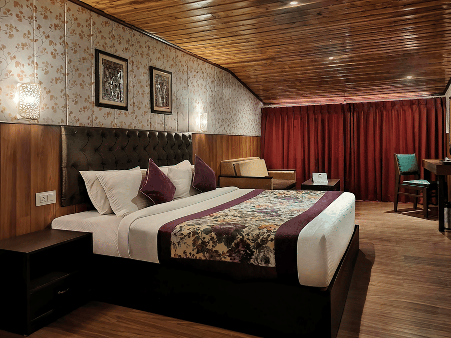 Elegant double bedroom with plush bedding and classic décor at Mount Thistle Boutique Hotel, Darjeeling.