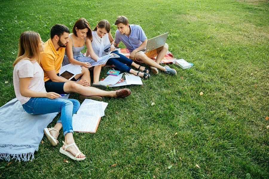 alt-text Group of kids reading book in garden