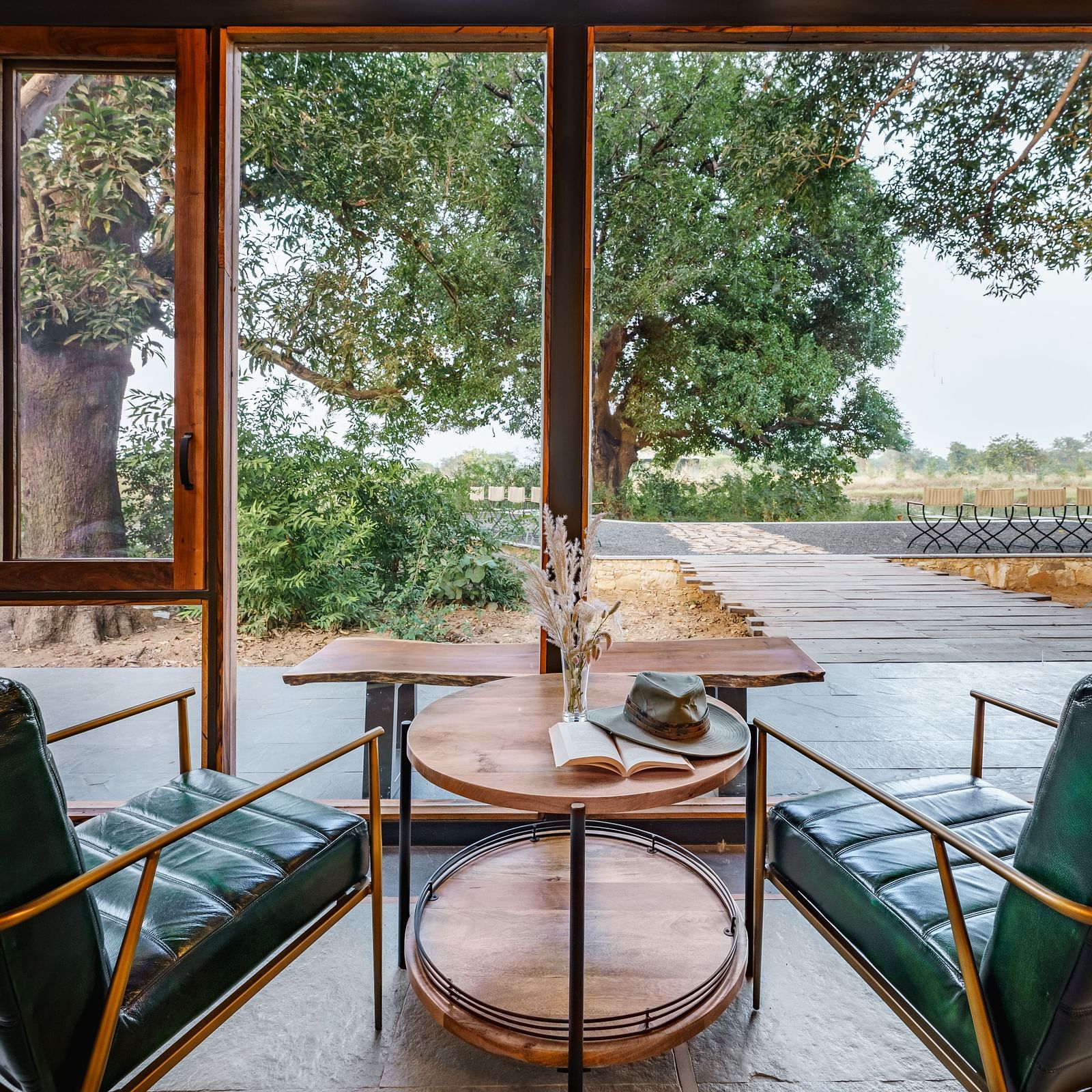 Two chairs and a small tea tale kept between them at Trees N Tigers, Tadoba.