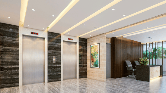 Hotel lobby with two elevator doors, marble flooring, and a reception desk
