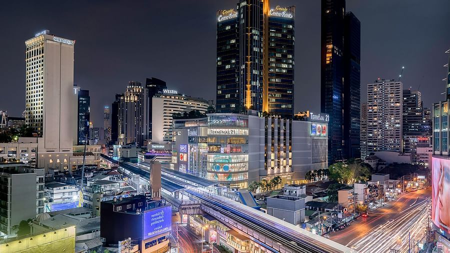 a wide angled view of Asok Montri Road at night