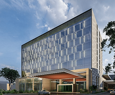 A facade of a building with trees and sky