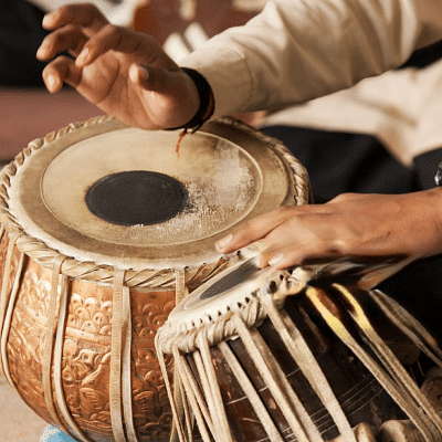 An image of tabla being played by a man.