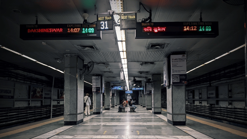Platform inside a Kolkata Metro station with digital train information displays.