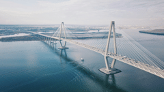 A hanging bridge connecting two lands separated by the sea, with the sky in background