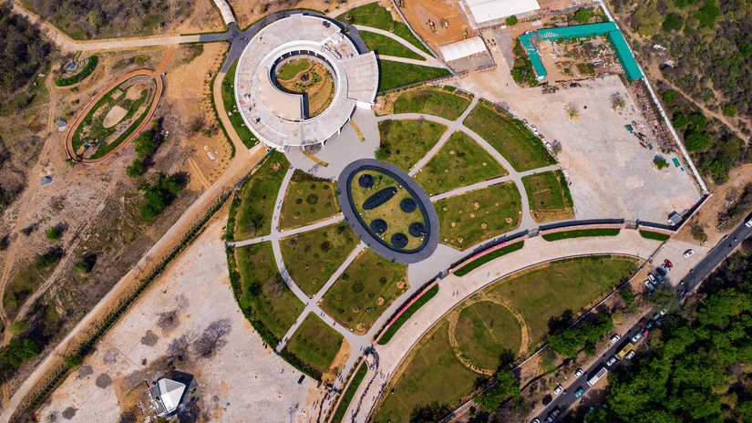View the expansive landscape of Tirupati Rushivan Adventure Park featuring gardens, rides, and attractions, easily accessible from Pride Elite Himatnagar.