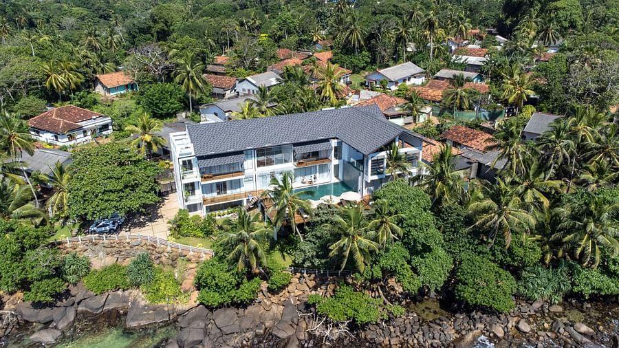 facade image of the beacon by the bay villas and suite at dondri nestled amidst tropical greenery 