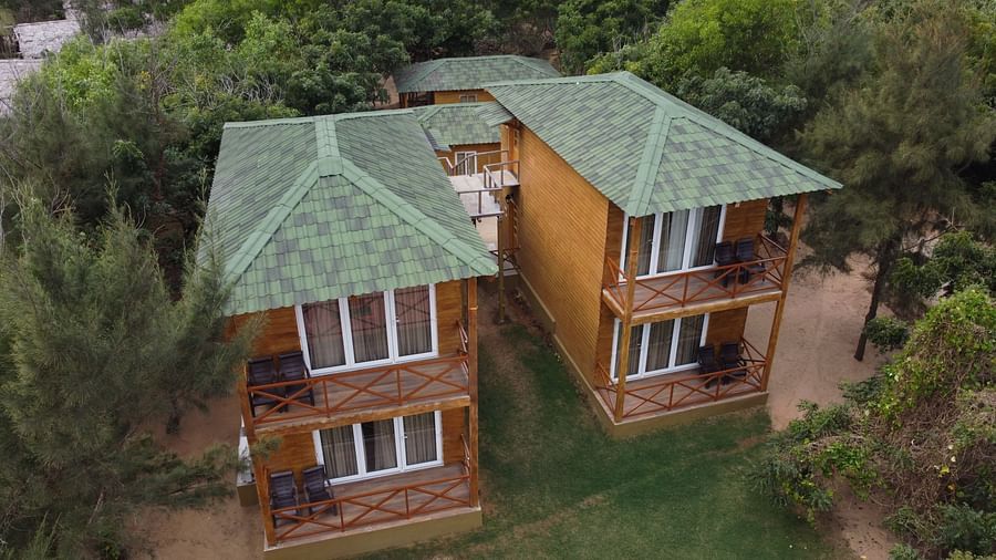 An aerial view of a charming twin villa with green roofs, expansive balconies, and surrounded by lush foliage, nestled in a serene environment-Lotus Eco Beach Resort Konark 