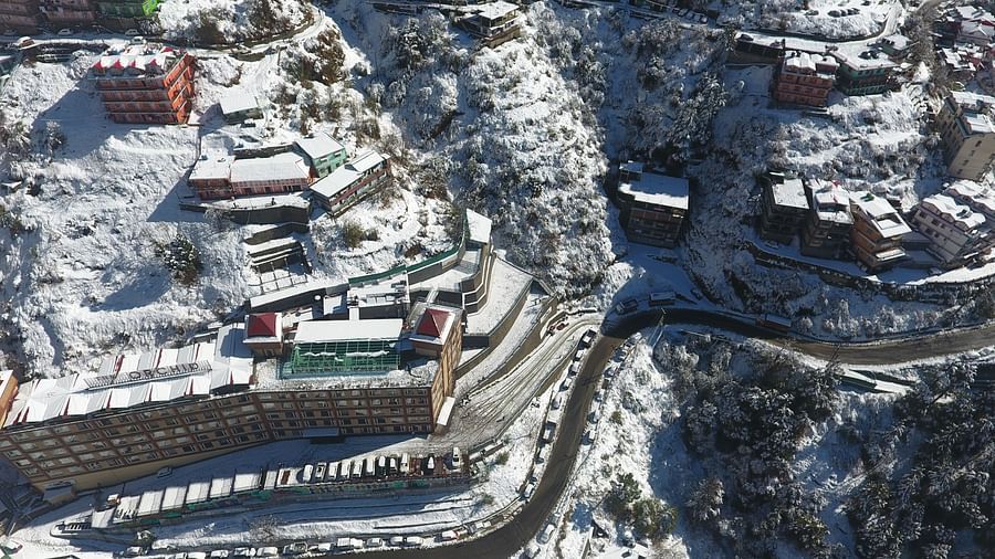 The aerial view of pathways and tracks on a snow-capped mountain - The Orchid Hotel Shimla