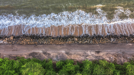 An overhead aerial shot showing the parallel layers of a coastal landscape.