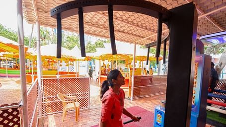 A Woman with a stick trying to jump towards a ride which is meant for hanging at MGM Dizzee World.