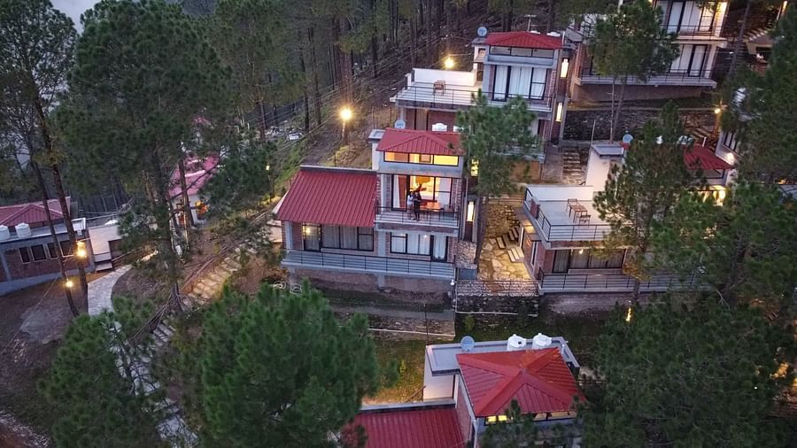 facade image of the BluSalzz Escapade Resort, Lansdowne surrounded by the trees.