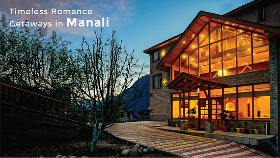 A facade of Clarks Inn Suites, Manali during sunset with the text saying 
