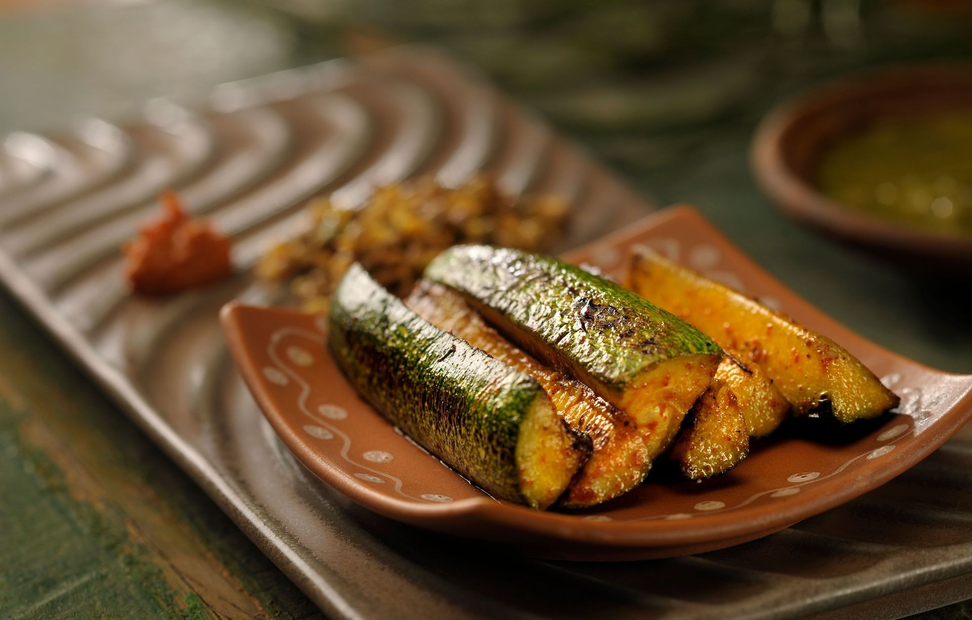 Roasted zucchini spears with a side of chutney.