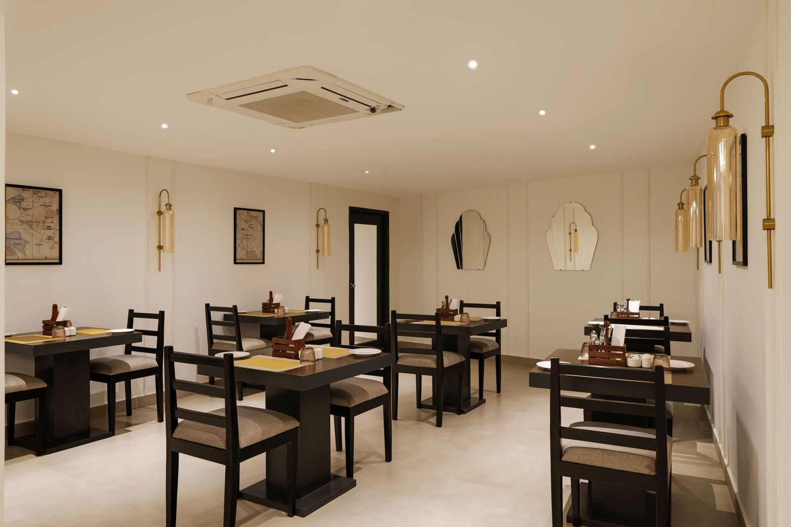 Restaurant at Shilton Suites, Bengaluru, with tables, chairs, and elegant interior furnishings.