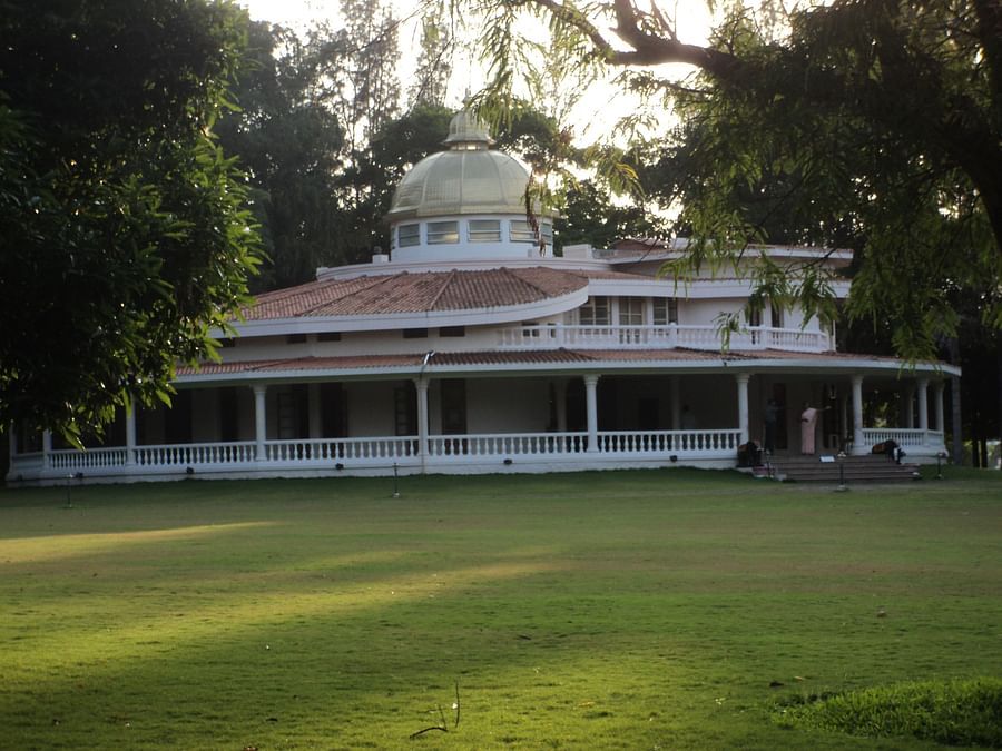 a building with grass in the foreground and covered by trees  - Ibex River Resort, Pollachi