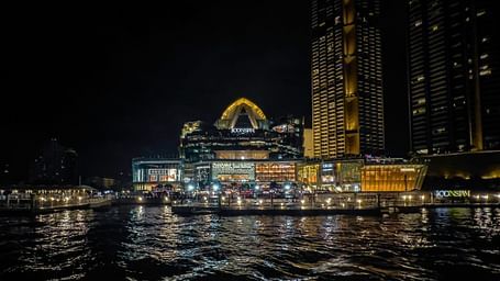 An overview of Chao Phraya River in the night with Iconsiam in view.